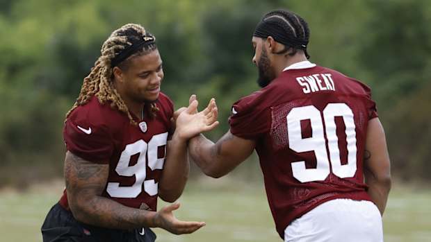 Jul 27, 2023; Ashburn, VA, USA; Washington Commanders defensive end Chase Young (99) and Commanders defensive end Montez Sweat (90) do extra work after morning practice during day two of Commanders training camp at OrthoVirginia Training Center.